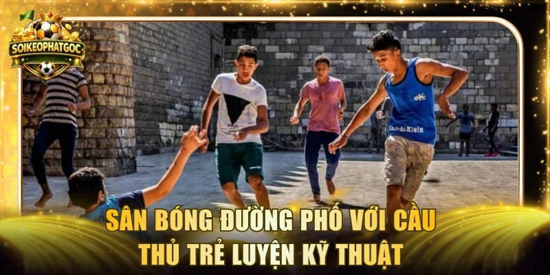 Sân bóng đường phố với cầu thủ trẻ luyện kỹ thuật